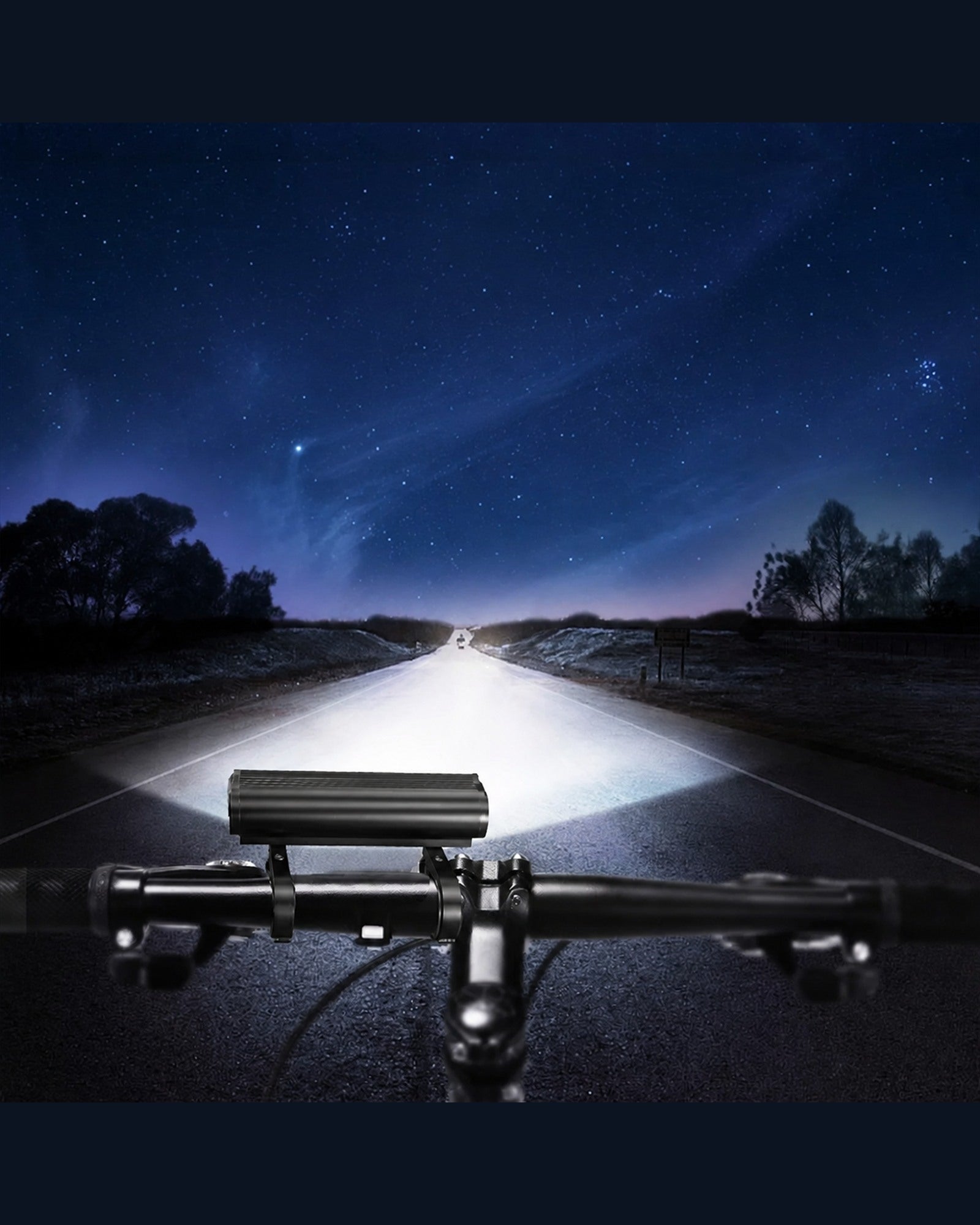 Multi-LED bike front light casting a wide beam along a road at night