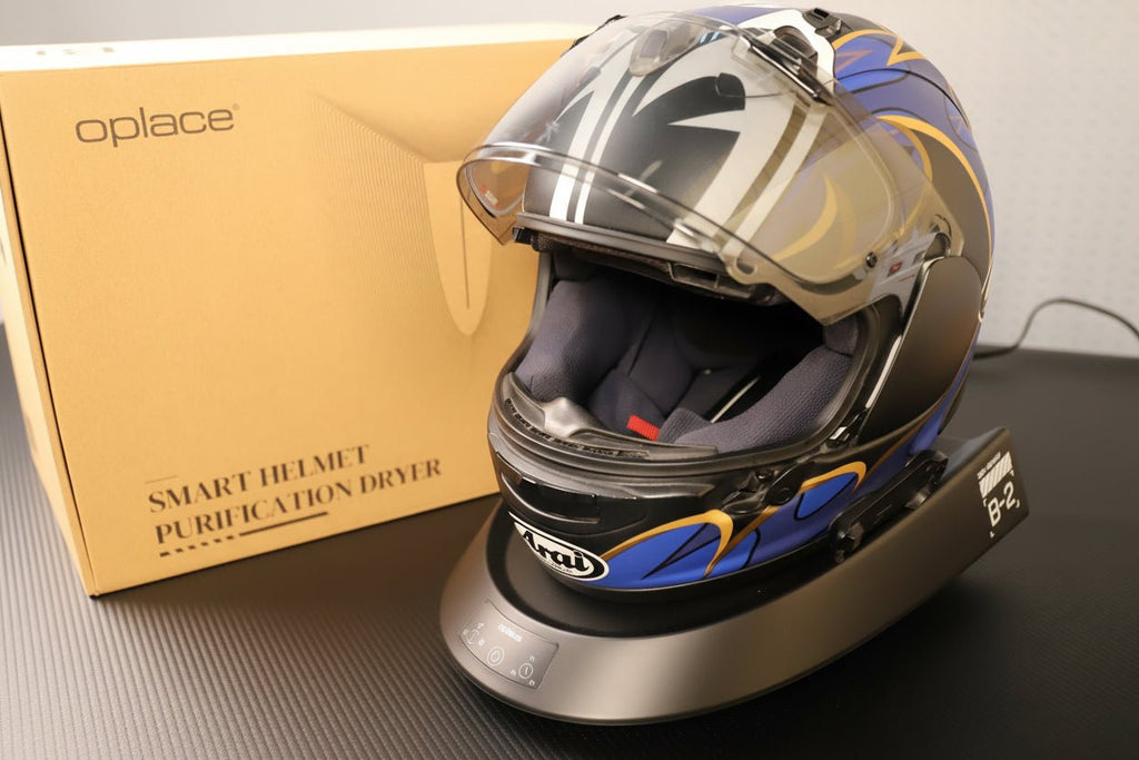 Smart Helmet and Gear Dryer Pro supporting a white and blue motorcycle helmet beside its box