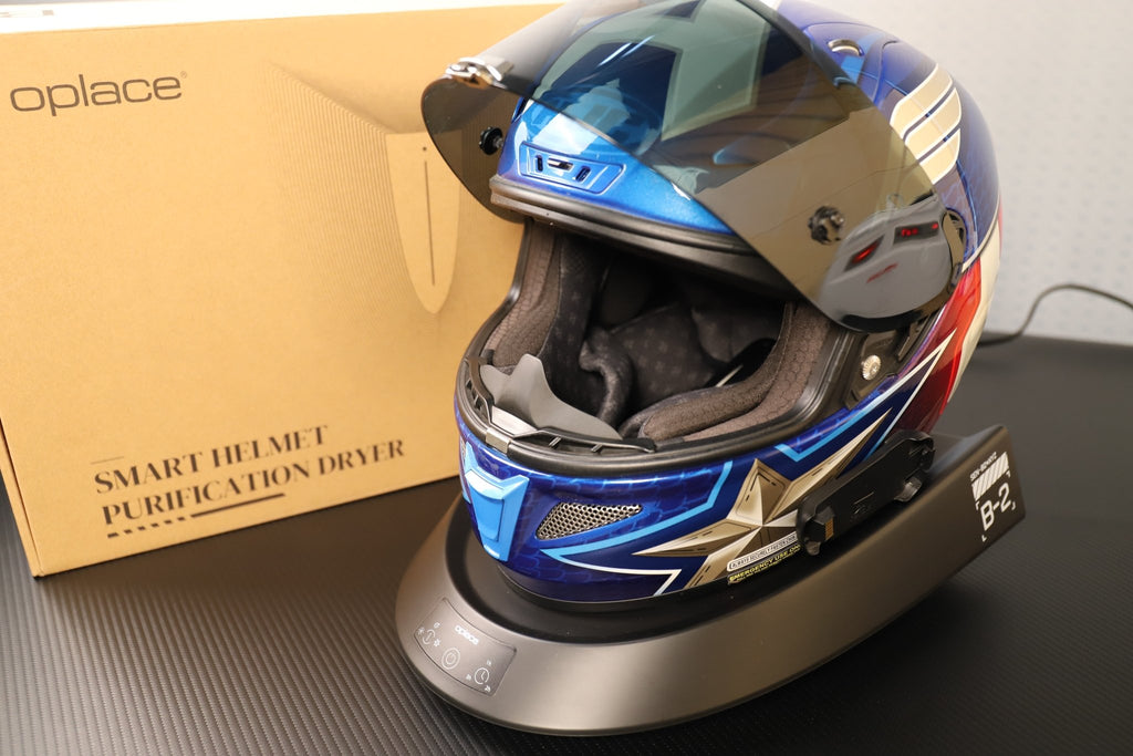 Smart Helmet and Gear Dryer Pro supporting a blue, white and red motorcycle helmet beside its box