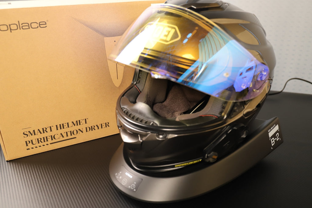 Smart Helmet and Gear Dryer Pro supporting a reflective motorcycle helmet beside its box