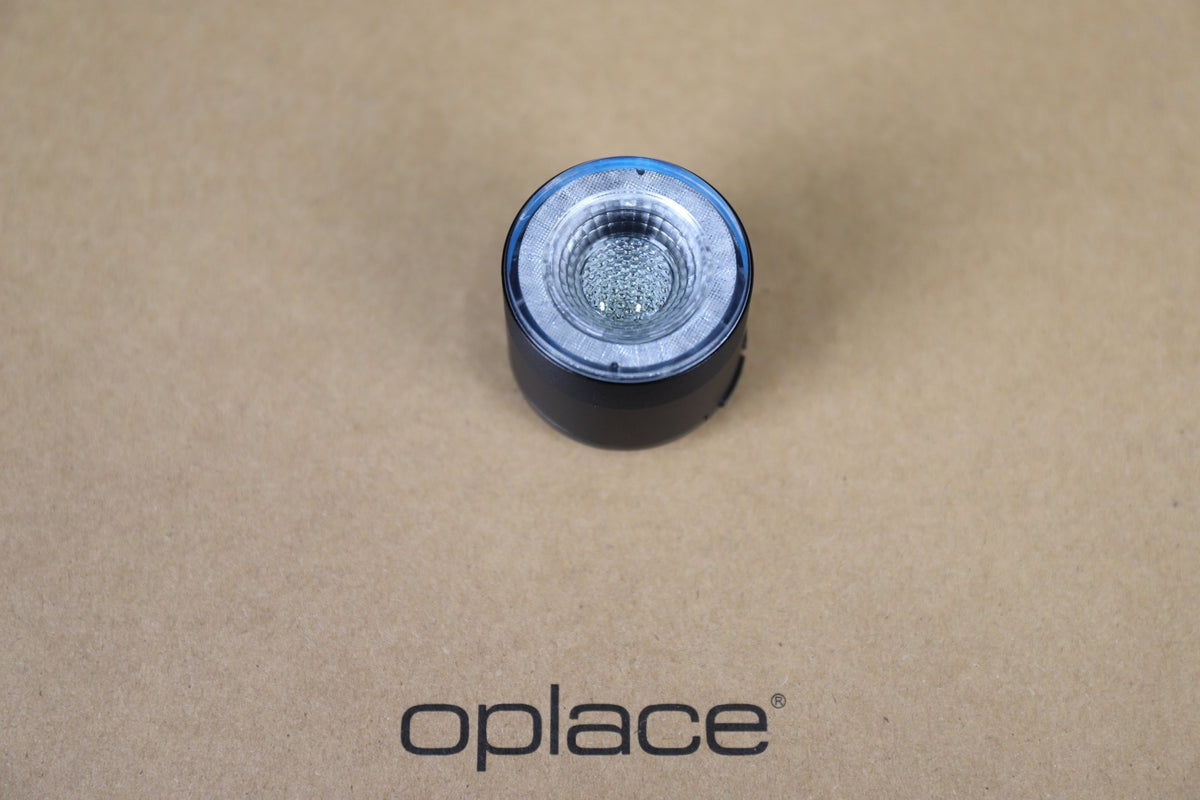 Single clear round RGB halo bike light shown from above on an OPlace background