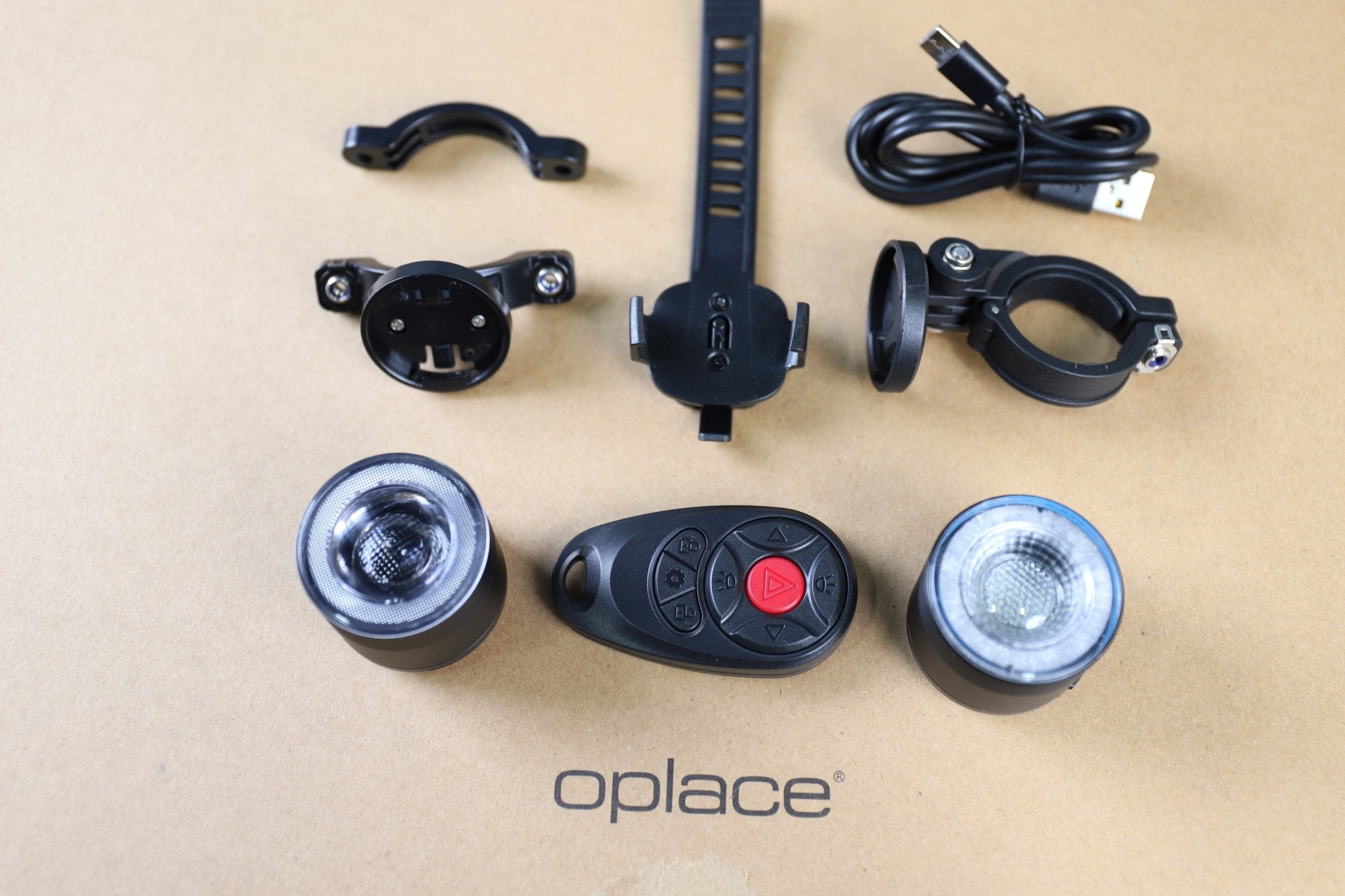RGB halo bike light set with two round lights, wireless remote, mounts and cables arranged together