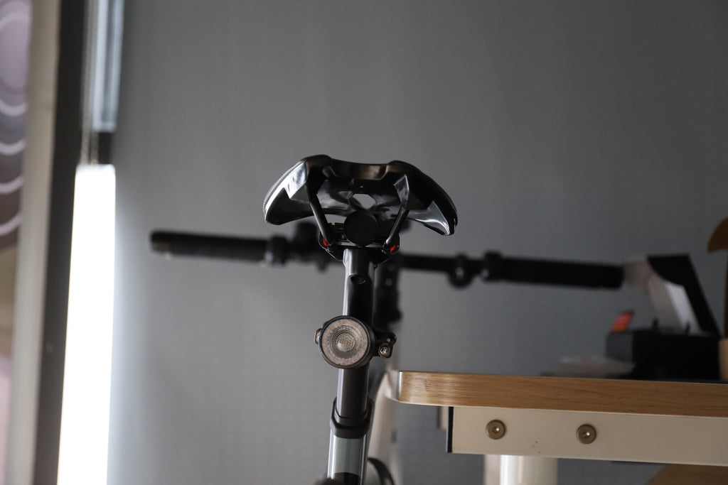 Front view of a bicycle with a round light mounted at the handlebar