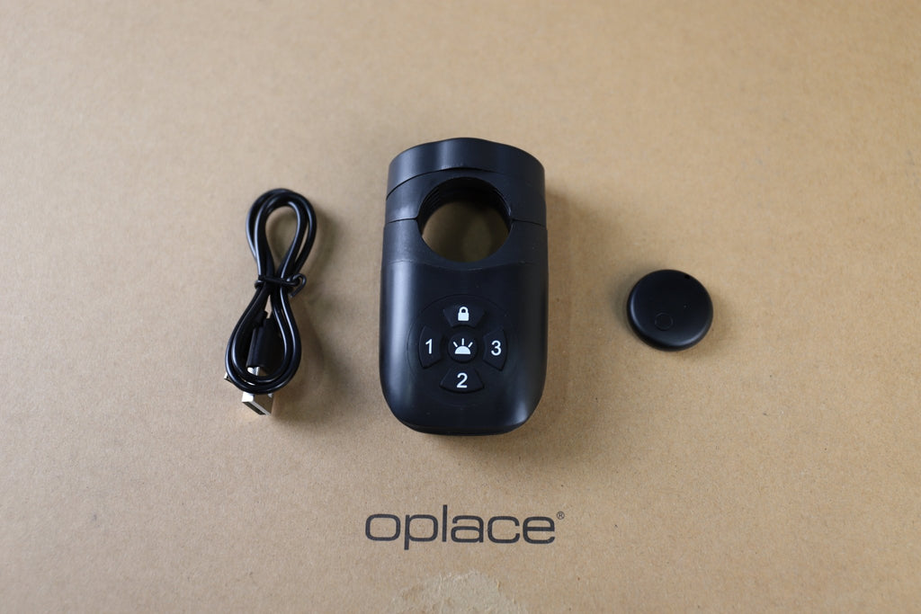 Find My-ready alarm bike tail light with wireless remote and cable arranged on an OPlace box