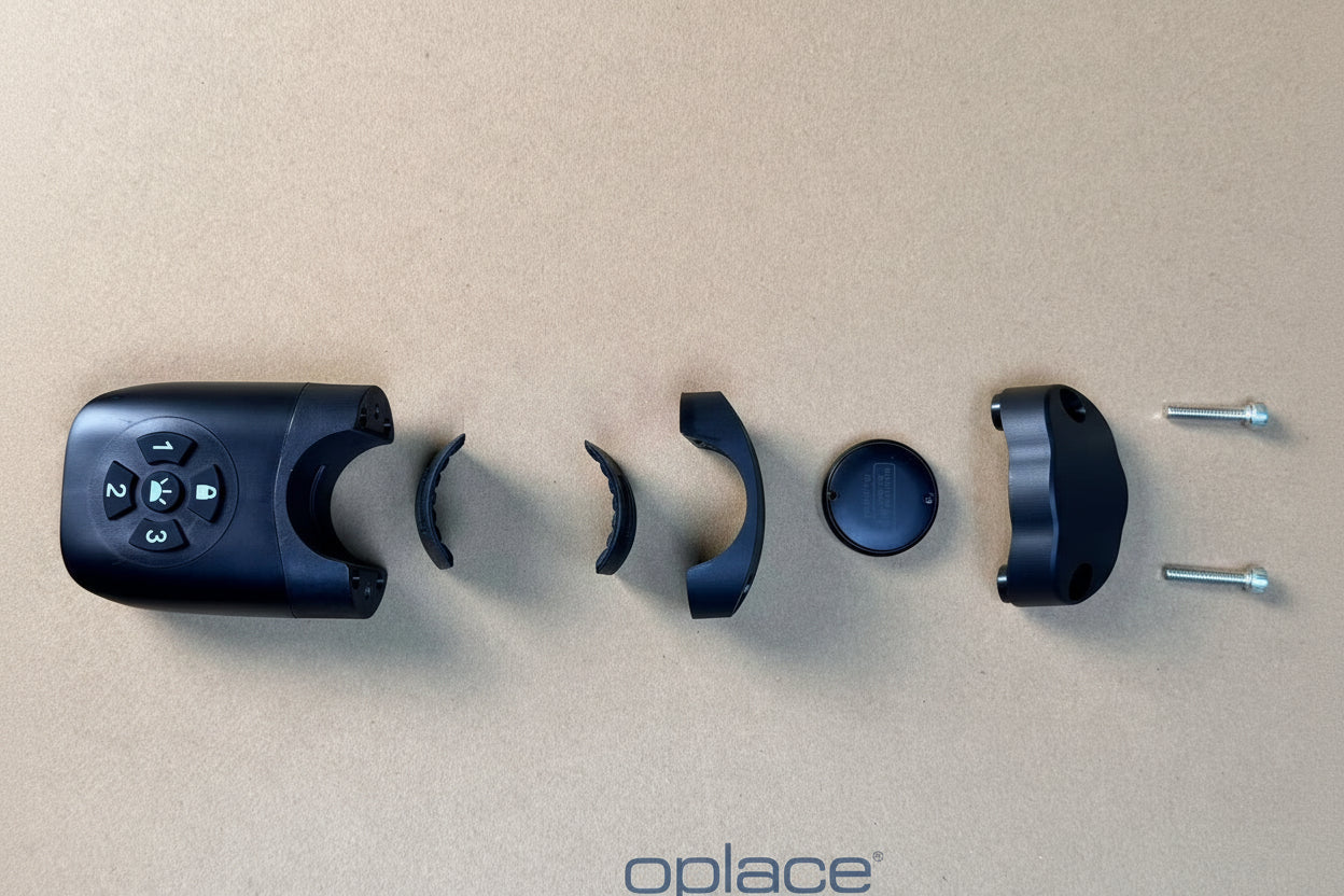 Disassembled Find My-ready bike tail light mount with bracket pieces, tracker cover and screws