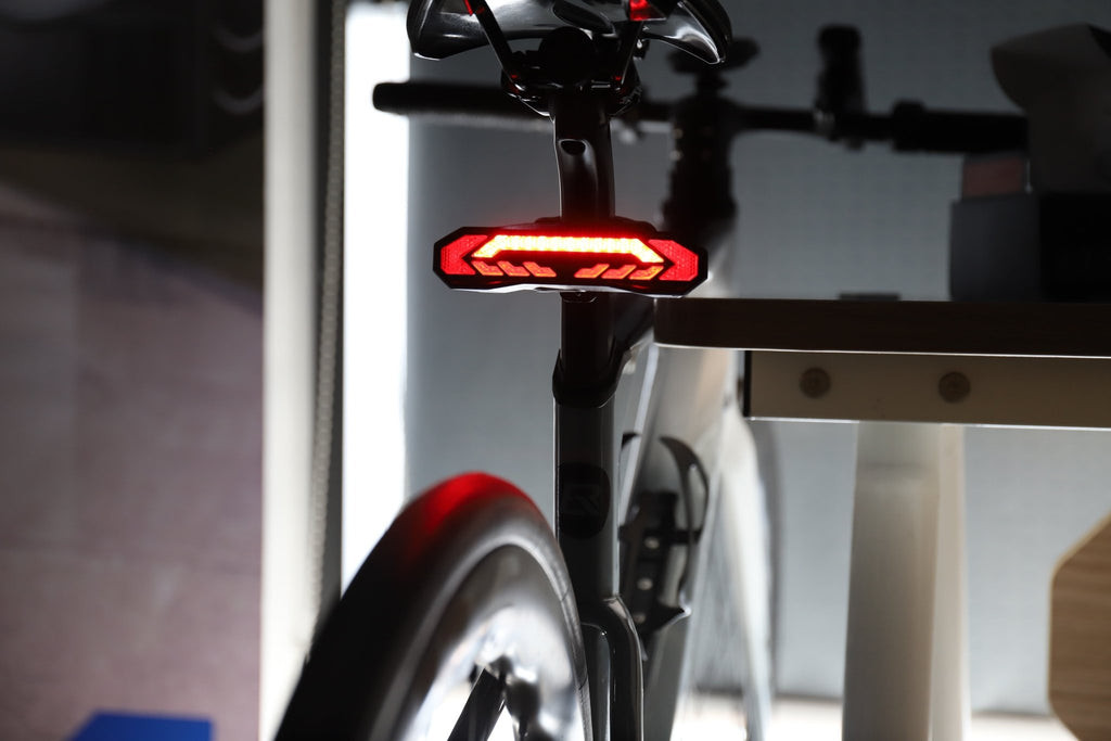 OPlace alarm tail light mounted below a saddle beside a rear rack
